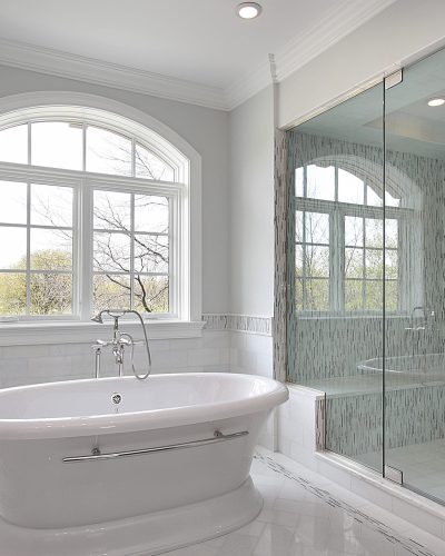 Master bath in new construction home with large glass shower